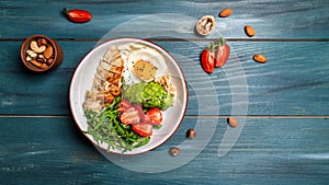 Buddha bowl with chicken, arugula and strawberries. keto diet food recipe background. Long banner format, top view