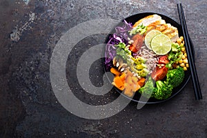 Buddha bowl dish with brown rice, avocado, pepper, tomato, cucumber, red cabbage, chickpea, fresh lettuce salad and walnuts. Healt