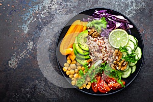 Buddha bowl dish with brown rice, avocado, pepper, tomato, cucumber, red cabbage, chickpea, fresh lettuce salad and walnuts. Healt photo