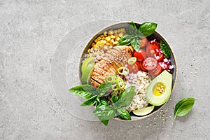 Buddha bowl with grilled chicken breast, tomato, onion, corn, avocado, fresh basil salad and rice, healthy balanced eating