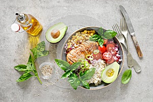 Buddha bowl with grilled chicken breast, tomato, onion, corn, avocado, fresh basil salad and rice, healthy balanced eating