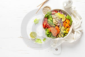 Buddha bowl with grilled salmon fish, fresh cucumber, tomato, onion, sweet pepper, avocado, lettuce salad and rice