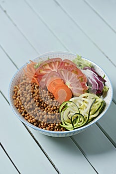 Buddha bowl on a pale green table