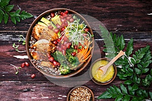 Buddha Bowl with Quinoa, Avocado, Roasted Chicken, Broccoli, Carrots and Turmeric Sauce photo