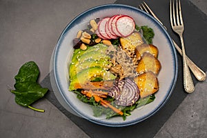 Buddha bowl, a salad of baked vegetables, quinoa with rice, avocado and tofu