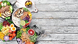 Buddha bowl on a white wooden background. Assortment of healthy food. Top view.