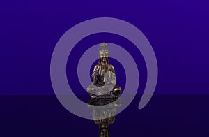 Buddha of bronz on the beautiful background of blue cobalt