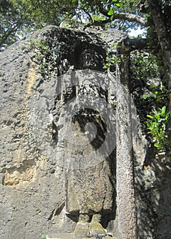 Buddha carved on mountain rock cliff â€œ The large unfinished Buddha image at Dhowa Raja Maha Vihara or The Dhowa rock temple in