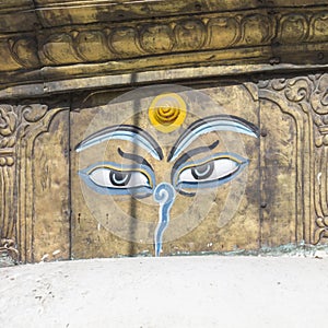 Buddha eyes close up with prayer flags at Bodhnath stupa in Kathmandu valley, Nepal