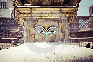 Buddha eyes close up with prayer flags at Bodhnath stupa in Kathmandu valley, Nepal