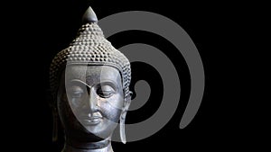 Buddha face closeup isolated on black