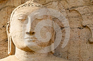 Buddha face on yellow stone