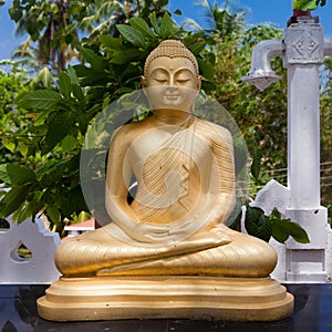 Buddha gold statue in Matara, Sri Lanka.