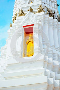Buddha golden arches on top of a white pagoda and blue sky
