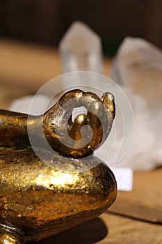 Buddha hand in front of a rock crystal