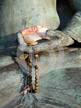 Buddha: hand with mala beads