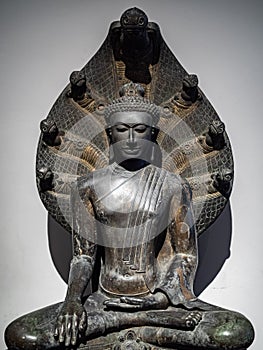 Buddha image in the gesture of touching earth and sheltered by serpents