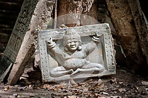 Buddha image on a part of a broken stone relief at Wat Umong, Chiang Mai, Thailand