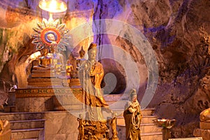 Buddha images in various postures are enshrined inside the famous Tham Khao Yoi Temple.