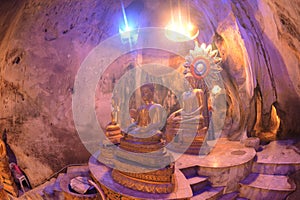 Buddha images in various postures are enshrined inside the famous Tham Khao Yoi Temple.