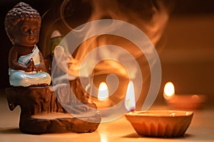 Buddha incense and diya