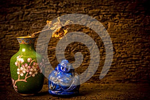 Buddha Lapis Lazuli cloisonne with ornamental vase on shelf