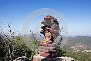 Buddha meditate and protective cover head by mythical serpent or Nak Prok Buddha Sheltered by naga hood on cliff of Khao Phraya