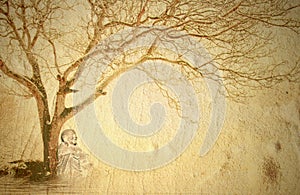 Buddha meditating under a tree