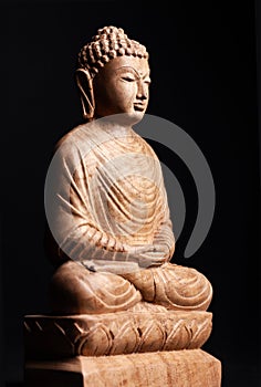 Buddha in a meditation pose, made of wood.