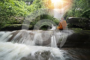 Buddha monk practice meditation at  waterfall