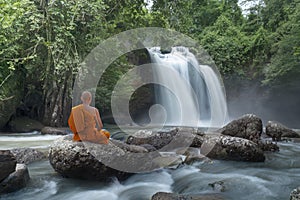 Buddha monk practice meditation at  waterfall