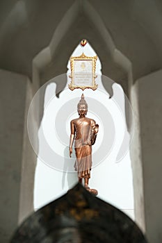 Buddha near wall in front of temple