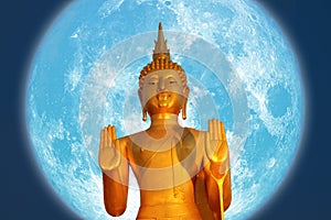 Buddha pacifying the ocean and super blue moon on night sky in the Asanha bucha day