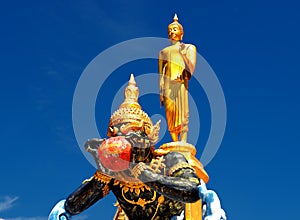 Buddha and Phra Rahu soaring into blue sky photo