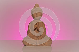 Buddha on a pink background. Buddhism symbol .Meditation and relaxation