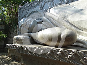Buddha resting in the garden of the Asian temple.