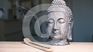 The Buddha's head in the home interior. The atmosphere of the prayer room. The altar.