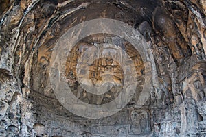 Buddha sculpture on cave wall in Longmen Grottoes