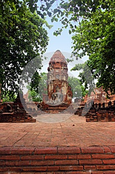 Buddha sculptures made of stone on the brick ruins of Wat Phra Sri Sanphet. Ayutthaya, Thailand.