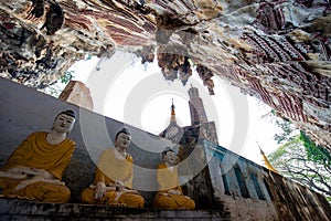 The Buddha sits in the Kaw Goon Cave in Hpa An Town, Kayin State, Myanmar. It is a natural limestone cave