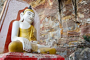 The Buddha sits in the Kaw Goon Cave in Hpa An Town, Kayin State, Myanmar. It is a natural limestone cave.