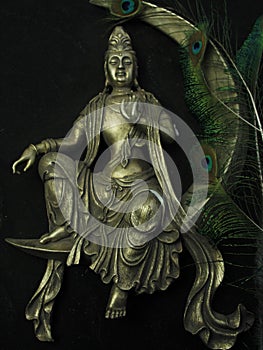 Buddha sitting on the moon, peacock feathers