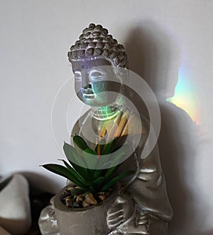Buddha sitting in a rainbow