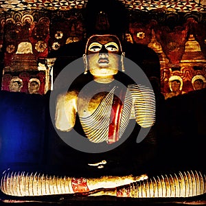Buddha sitting in Sri Lanka dark shadow light photo