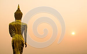 Buddha statue background over scenic sunrise sky twilight color