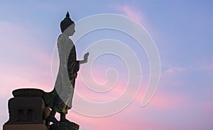 Buddha statue background at peace stand at sunset Twilight color beautiful sky at phutthamonthon Thailand