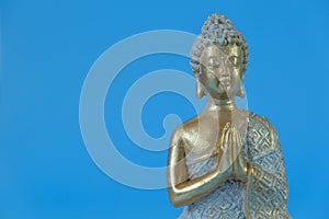 Buddha statue on a blue background.Meditation and relaxation symbol.Buddhism religion background.Buddhism religion .