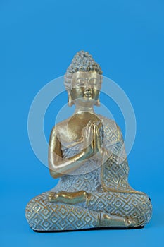 Buddha statue on a blue background.Meditation and relaxation symbol.Buddhism religion .Meditation and relaxation ritual.