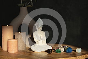 Buddha statue, candles and gemstones. Balance energy flow, purifying air, decrease stress