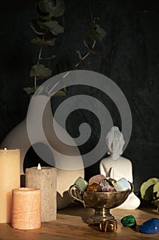 Buddha statue, candles and gemstones. Balance energy flow, purifying air, decrease stress